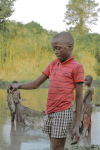 A boy holding fresh fish