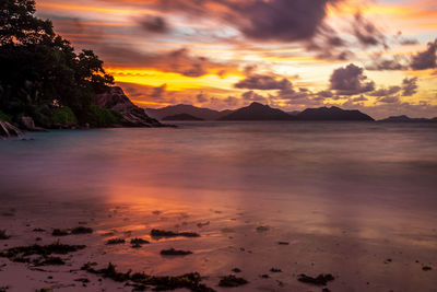 Scenic view of sea against orange sky