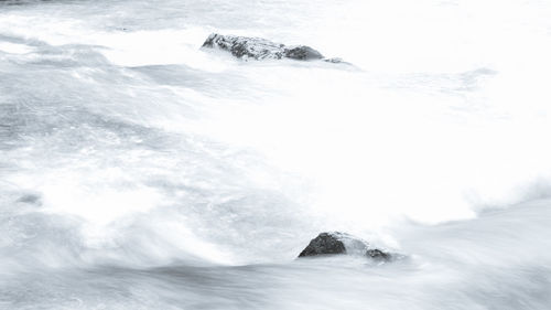 Scenic view of sea against snowcapped mountains