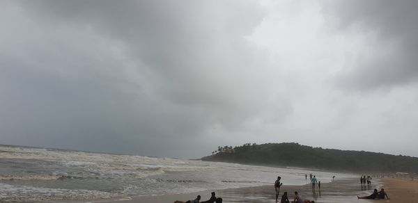 People on beach against sky