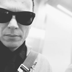 Close-up portrait of young man wearing sunglasses