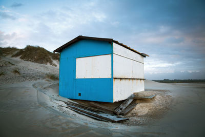 Built structure on beach against sky