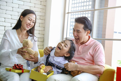 Smiling young woman sitting at home