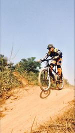 Man riding motorcycle on dirt road