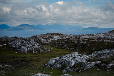 Scenic view of sea and mountains against sky