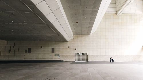 Rear view of man walking in building