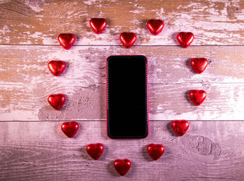 Directly above shot of red heart shape on table