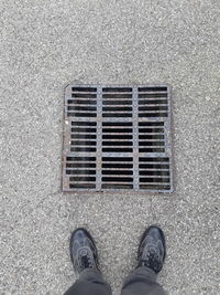 Low section of person standing on the road