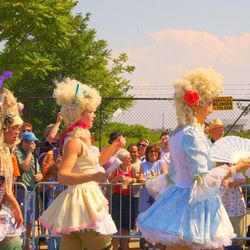 People in traditional clothing dancing against sky