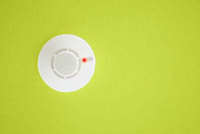 Directly above shot of electric lamp against green background