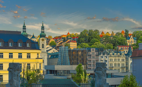 Buildings in city against sky