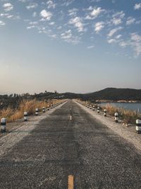 Road by city against sky
