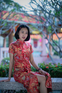 Portrait of smiling girl sitting outdoors