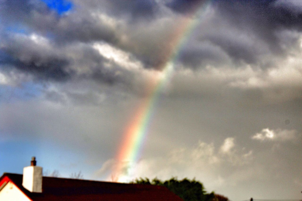 sky, cloud - sky, rainbow, low angle view, cloudy, built structure, building exterior, architecture, weather, cloud, beauty in nature, nature, multi colored, storm cloud, overcast, scenics, dramatic sky, outdoors, high section, no people