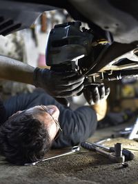 Close-up of man repairing car in workshop