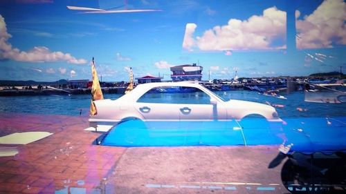 Boats in river against blue sky
