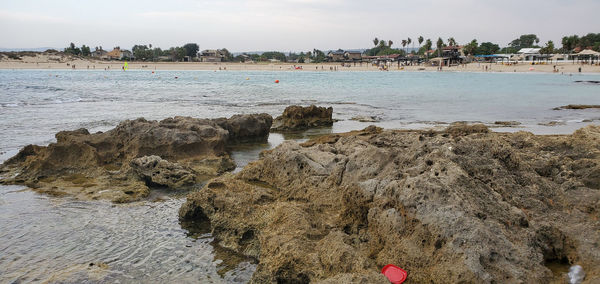 Rocks on beach against sky