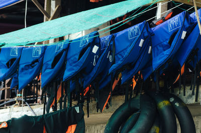 Close-up of clothes hanging in row