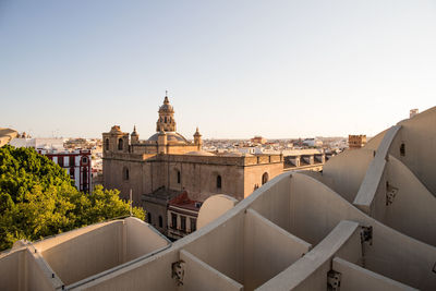 Buildings in city against clear sky