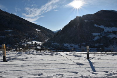 Scenic view of snow covered mountains against sky