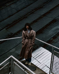 Portrait of woman standing on staircase