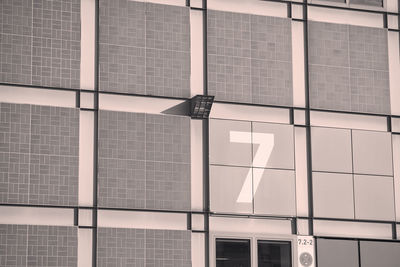 Low angle view of text on glass building