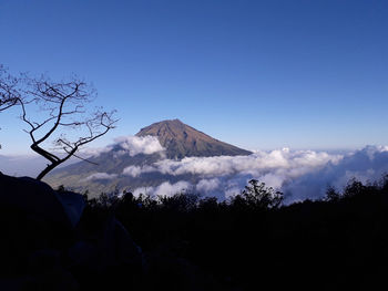 Scenic view of mountains against blue sky