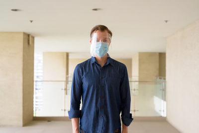 Portrait of man standing in corridor