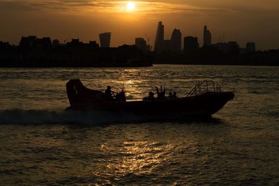 Boat in sea with buildings in background