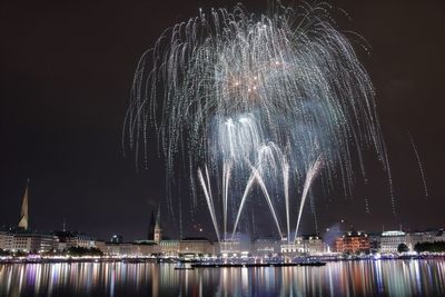 Low angle view of firework display at night