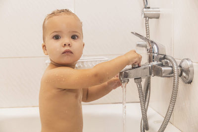 Close-up of boy washing hands