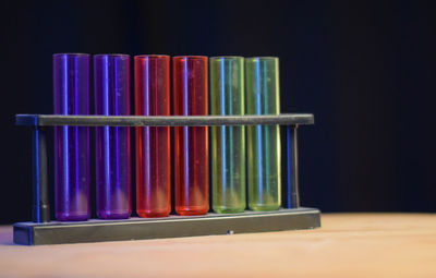 Close-up of multi colored bottles on table