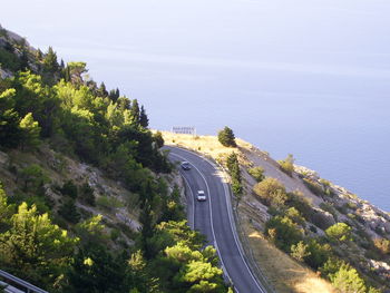 High angle view of road by sea against sky