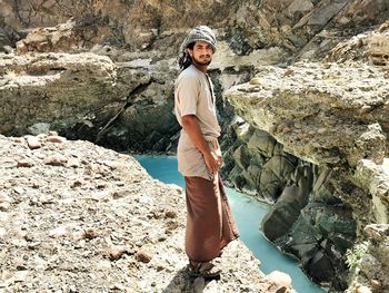 Full length of man standing on rock