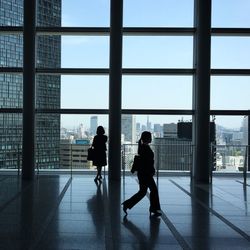 People standing in glass building