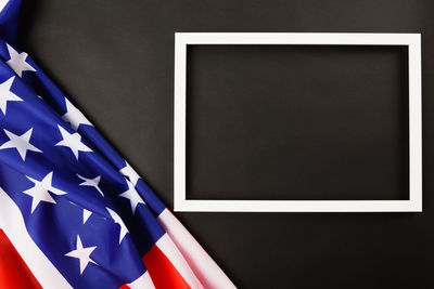 Close-up of flags against blue wall