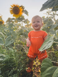 Portrait of girl standing in a sunflower landscape 