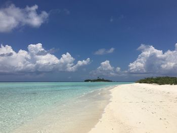 View of beach against cloudy sky