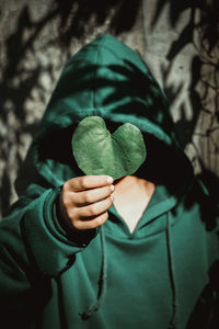 Close-up of hand holding leaf outdoors