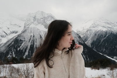 Young woman on snowcapped mountains during winter