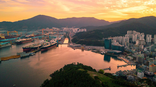 Aerial view of cityscape and sea during sunset