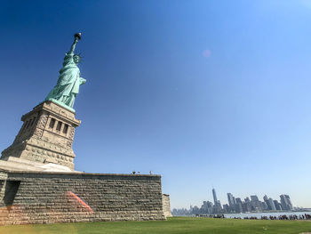 Low angle view of statue against blue sky