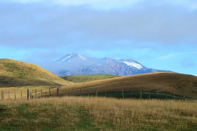 Scenic view of mountain against cloudy sky