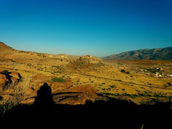 Scenic view of landscape against clear blue sky