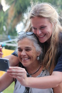 Portrait of smiling woman using mobile phone