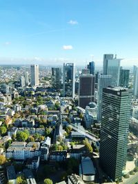 Aerial view of modern buildings in city against sky