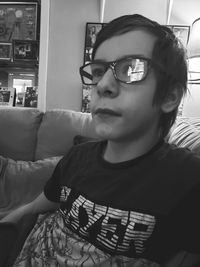 Portrait of man sitting on sofa at home