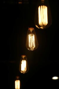 Close-up of lit candle in dark room