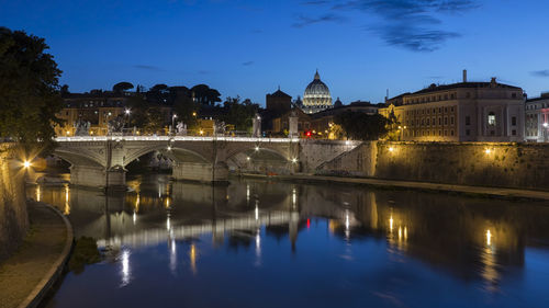 Ponte sant angelo over tiber river in city at dusk