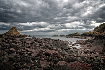 Scenic view of sea and mountains against sky